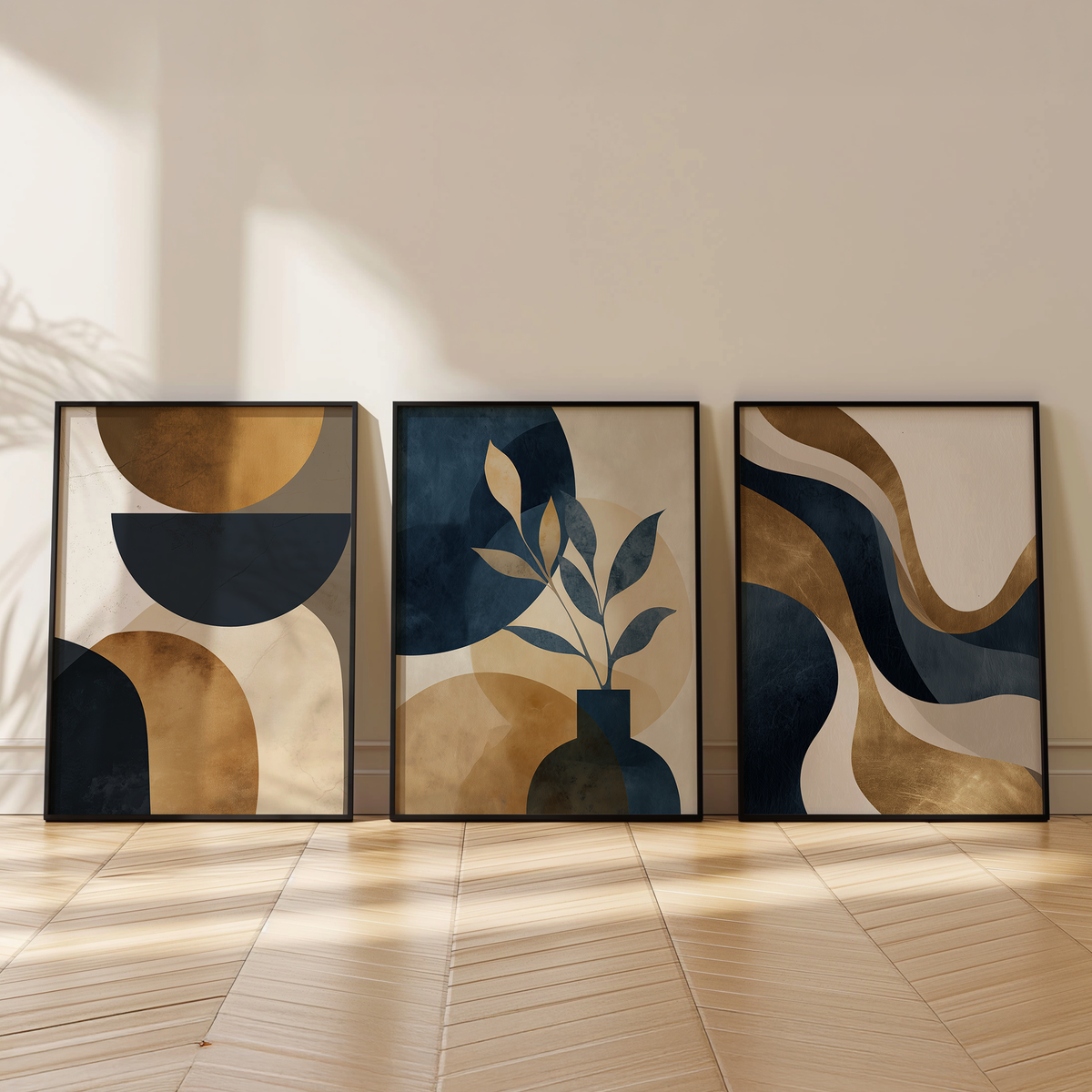 Three abstract wall art prints featuring organic shapes and botanical forms in muted blue, beige, and warm brown tones, displayed leaning against a neutral wall on a hardwood floor.
