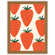 Strawberry wall art print featuring oversized red strawberries against a warm off-white background in an oak frame.