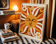 Retro wall art print featuring a vibrant sun face and cheerful daisies in warm colours  - Lifestyle Image