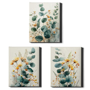 Three vertical canvas wall art prints arranged on a white background, each featuring botanical artwork with teal-green eucalyptus leaves and small yellow-orange flowers on a light cream backdrop.